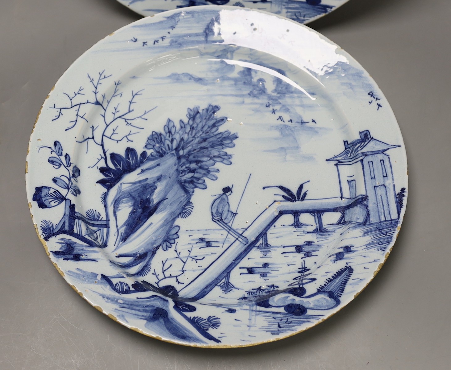 A pair of mid 18th century Delft blue and white chargers, 33.5cm diameter